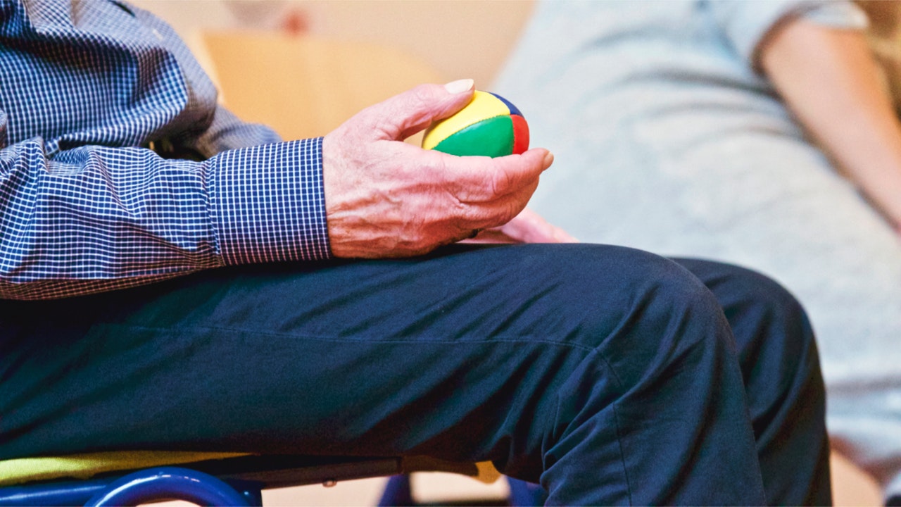 Elderly holding Rugby Ball